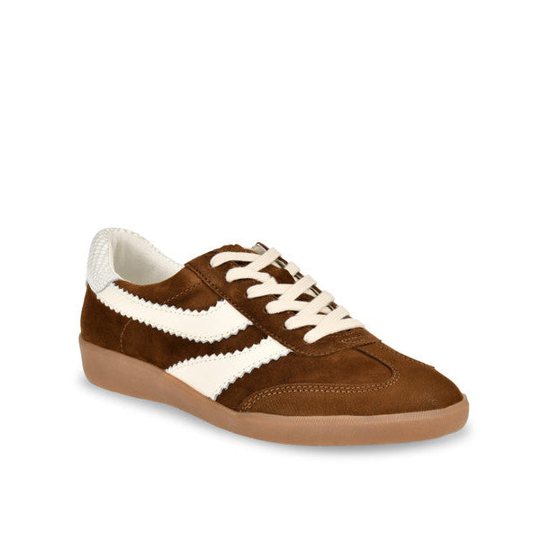 A brown suede low-top sneaker with cream-colored side stripes, laces, and collar lining, paired with a gum-colored sole, shown against a plain white background.